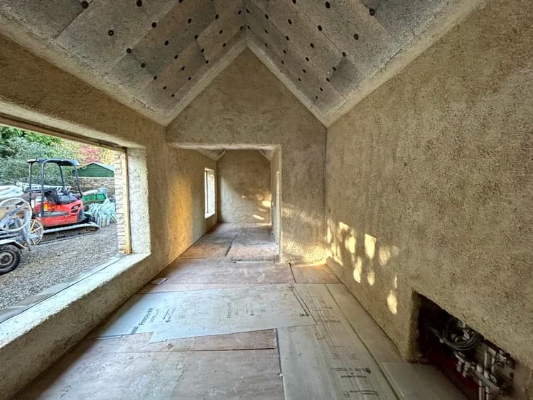 Full interior of a barn conversion with hempcrete sprayed to walls and pitched ceiling