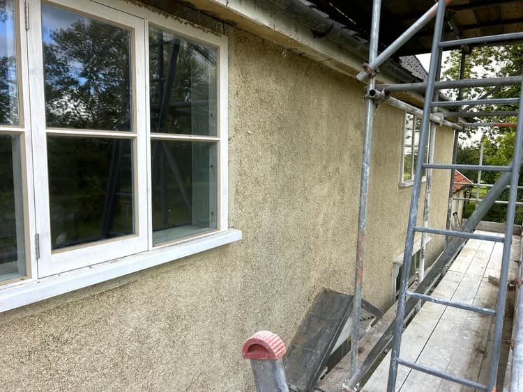 Exterior hempcrete render coat on a residential property with scaffold