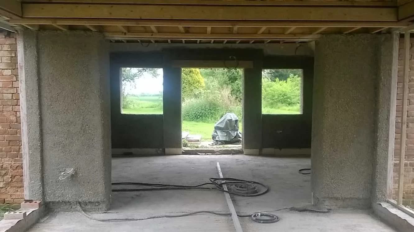 Hempcrete sprayed into brick kitchen extension with embedded timber noggins