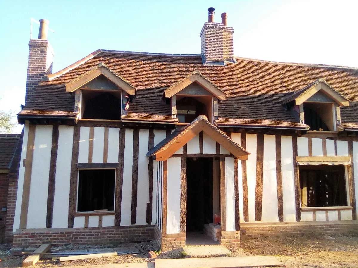 Finished lime plaster over hempcrete in the restored timber-framed building