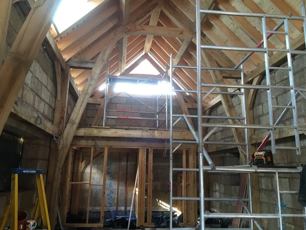 Giant hempcrete blocks infilling an oak timber frame, under construction